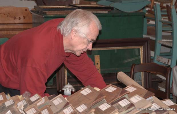Hotel historian Bill Defibaugh pores over old guest ledgers in the hotel's archives. Photo courtesy Mary Dorner